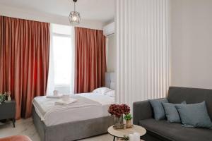 a hotel room with a bed and a couch at Olympia 1 in Xanthi