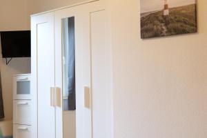 Μια τηλεόραση ή/και κέντρο ψυχαγωγίας στο Ferienhaus Otterndorf Haus Resi