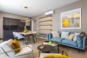 a living room with a blue couch and a table at ADRIAN LUXURY 5 Star in Dubrovnik