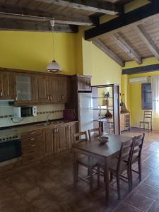 a kitchen with a wooden table and a dining room at APARTAMENTOS MATARRANYA in Valderrobres