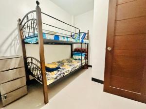 two bunk beds in a room with a closet at The George Residence in Tarlac