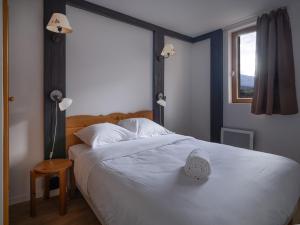 Ένα ή περισσότερα κρεβάτια σε δωμάτιο στο SUNWEB Les Terrasses de Termignon - Val-Cenis