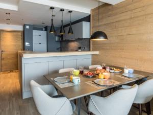 a dining room with a table and chairs at Appartement au centre de Tignes avec terrasse et Wifi - FR-1-641-82 in Tignes +9 photos