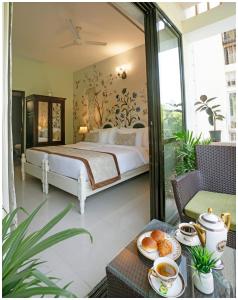 a bedroom with a bed and a table with food on it at Luxury Heritage Umaid 3BHK Apartment Jodhpur in Jodhpur
