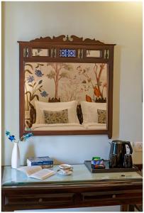 a mirror on a wall above a table at Luxury Heritage Umaid 3BHK Apartment Jodhpur in Jodhpur