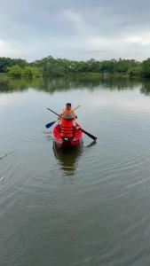 a man in a red kayak on a lake at Bài Văn Garden Homestay in Ba Vì +40 photos