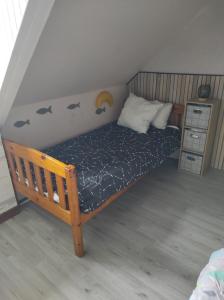 ein kleines Bett in einem Zimmer mit einem Nachttisch in der Unterkunft ty anna in Le Palais