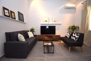 a living room with a couch and a tv at Casa Campagnolo in Corfu