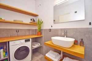 a bathroom with a washing machine and a sink at Casa Campagnolo in Corfu +24 photos