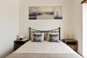 a bedroom with a large bed with two night stands at Feel Discovery Quinta do Muro Douro Valley in Peso da Régua +7 photos