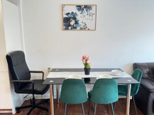 a dining room table and chairs with a vase of flowers at Superb Apartment CR0 in Croydon +13 photos