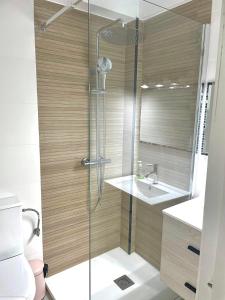 a bathroom with a shower and a toilet and a sink at Bello Horizonte Apartman 4B in Salou +30 photos