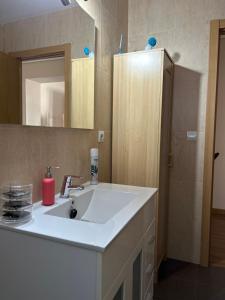 a bathroom with a white sink and a mirror at Sevilla Nervion Santa Justa in Seville +45 photos