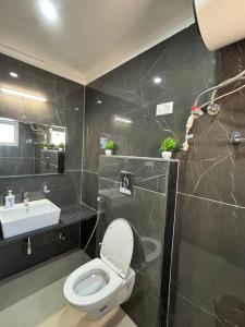 a bathroom with a toilet and a sink at Sukoonat Gah in Srinagar +6 photos
