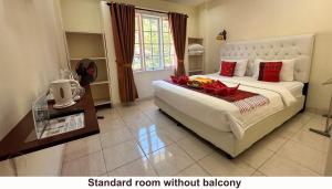 a bedroom with a large bed with aamed room without jealousy at Zoé’s Paradise Waterfront Hotel in Tuktuk Siadong