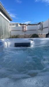 a large swimming pool with water in a backyard at L'OASIS BLEUE Spa et Terrasse in Sète