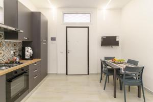 カターニアにあるAthena Apartamentのキッチン(テーブル、椅子付)、窓