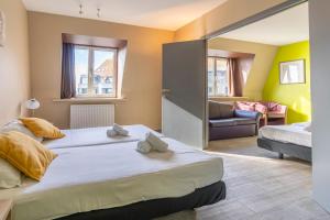 Postel nebo postele na pokoji v ubytování Sleep & Go Blankenberge