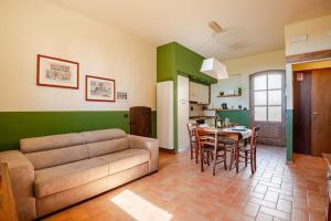 a living room with a couch and a table at Agriturismo La Torre dell'Oliveto in Agello
