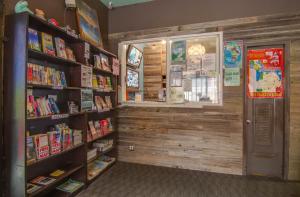 a book store with books on shelves and a window at Adelaide Hostel in San Francisco