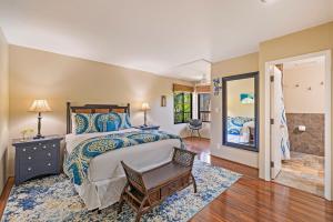 a bedroom with a bed and a chair in it at Kaanapali Royal Q-202 in Lahaina +32 photos