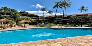 a large swimming pool in front of a building at Kaanapali Royal Q-202 in Lahaina