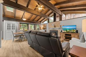 a living room with leather chairs and a television at Dolly Varden Cottage in Kings Beach