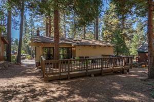 a small house in the woods with a porch at Dolly Varden Cottage in Kings Beach
