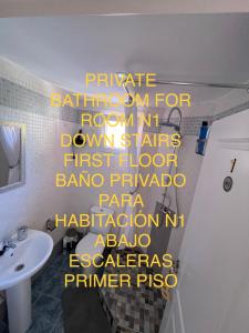 a bathroom with a sign on the wall with a sink at Marbella Deluxe Rooms in Royal Cabopino Townhouse in Marbella