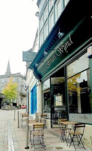 a group of tables and chairs outside of a store at Friars Wynd Guest Rooms in Stirling