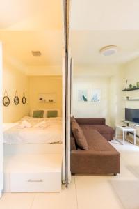 a bedroom with a bed and a couch at AIOLOS glyfada centre apartment 1 in Athens