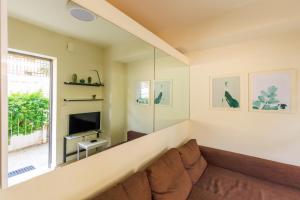a living room with a couch and a television at AIOLOS glyfada centre apartment 1 in Athens