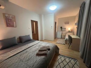 a bedroom with a bed with two towels on it at House Varna-4 in Krapets