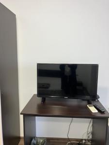 a flat screen tv sitting on top of a table at Studio Rayskata yabalka in Varna City +5 photos