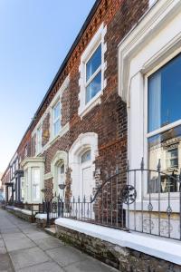 a brick building with white doors and windows at Arkles House - Air Host & Stay - Anfield in Liverpool