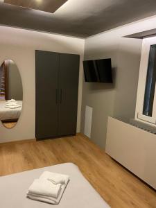 a bathroom with a black cabinet and a mirror at Albergo Ristorante Plaza in Tornolo