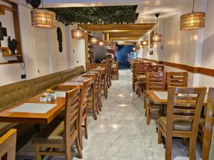 a row of tables and chairs in a restaurant at Amakonkay Machupicchu in Machu Picchu