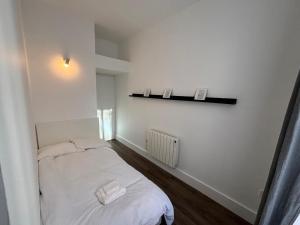 a bedroom with a bed with two towels on it at Temple bar - Entire 2 bedroom apartment in Dublin
