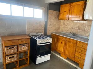 a kitchen with a stove and a sink at Cabañas los Cactus in San Rafael