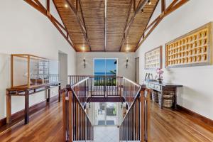 a staircase in a house with a wooden ceiling at The Cape Bali Luxury Villa with Ocean Views in Camps Bay in Cape Town