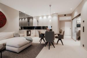 a living room with a couch and a table at Luxury penthouse apt with amazing views in Svolvær
