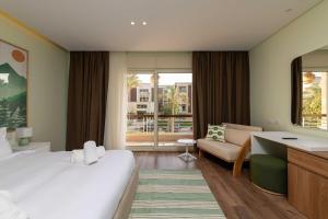 a hotel room with a large bed and a living room at Sheikh Zayed New Giza Near GEM & MOA in Abū Rawwāsh