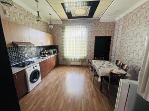 a kitchen with a table and a dining room at Villa in Mardakan,COP29 in Baku
