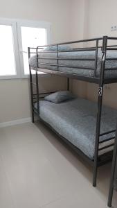 Łóżko lub łóżka w pokoju w obiekcie Hostel Las Rosas