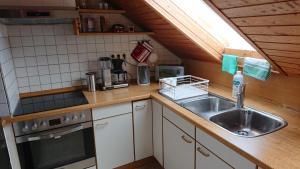a kitchen with a sink and a stove at Ferienwohnung in Ländliche Gegend die zum Verweilen einlädt in Wachenroth