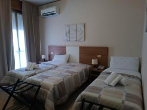 A bed or beds in a room at Hotel Mucciolini
