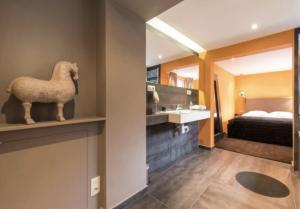 a hotel room with a statue of a horse on a shelf at Villa Sablon in Brussels +5 photos