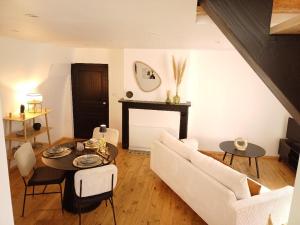 a living room with a couch and a table at Le Charmant in Sévérac d' Aveyron