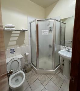 a bathroom with a shower and a toilet and a sink at U.S. Pacific Hotel in New York