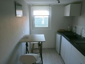 a small kitchen with a table and two chairs at L'escapade in Fontvieille